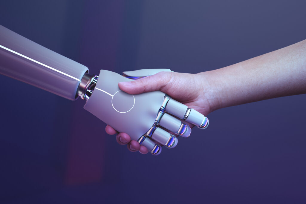 Human hand shaking a futuristic robotic hand, symbolizing AI collaboration